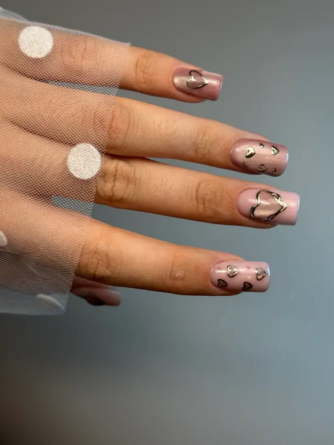 Silver chrome hearts on milky-pink square nails — 3D gel art, client work.