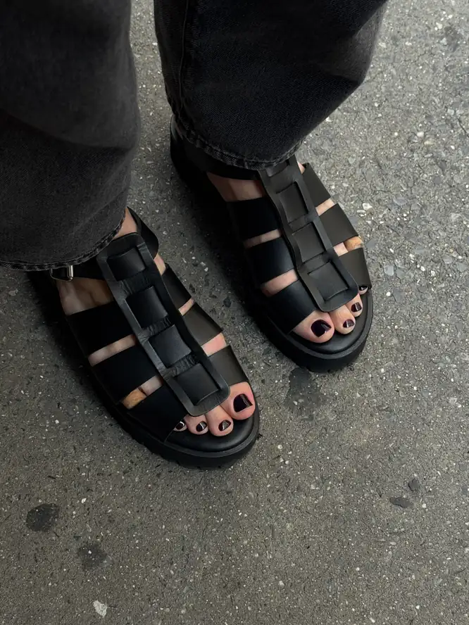 Dark-cherry gel pedicure, street-styled with leather sandals — client work.
